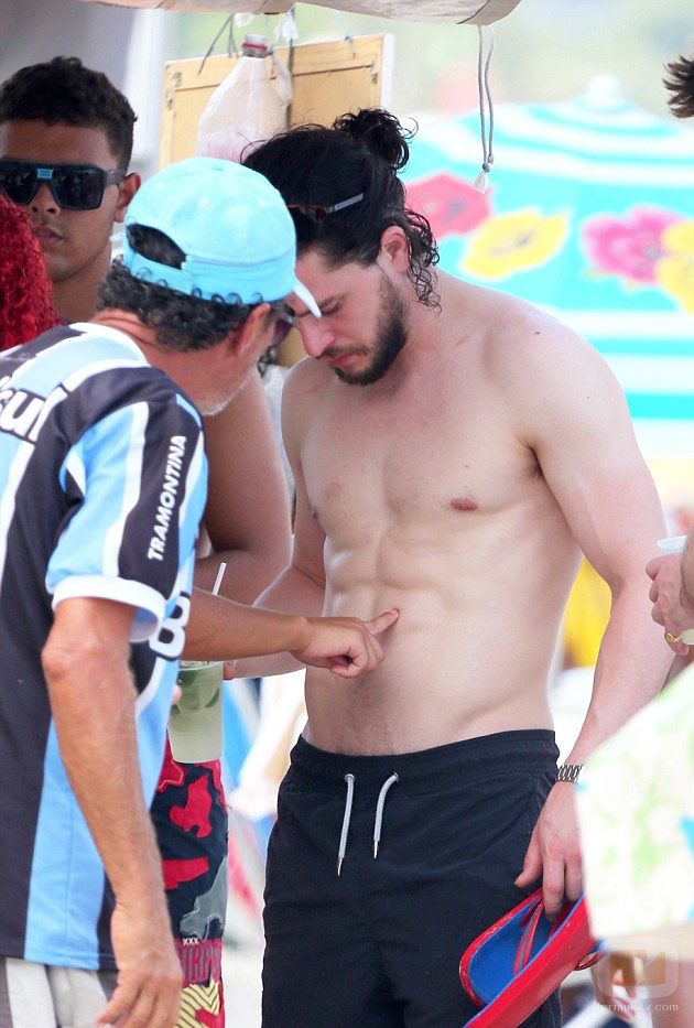 Una chica toca los abdominales de Kit Harington