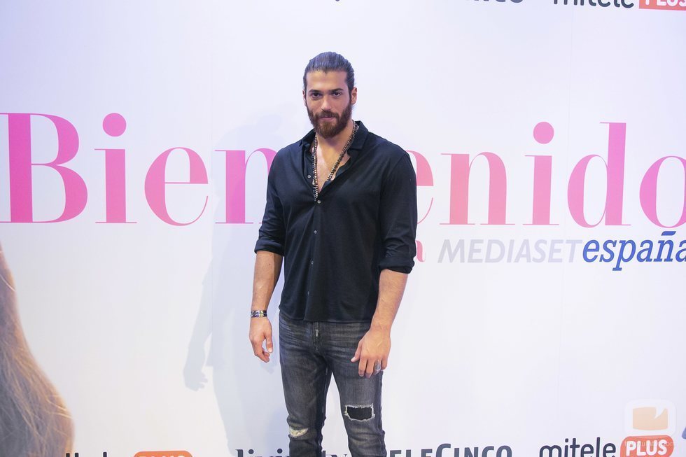 Can Yaman junto a un cartel que le da la bienvenida a España