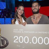 Alejandro Nieto posa junto a Tania Medina con el cheque del ganador