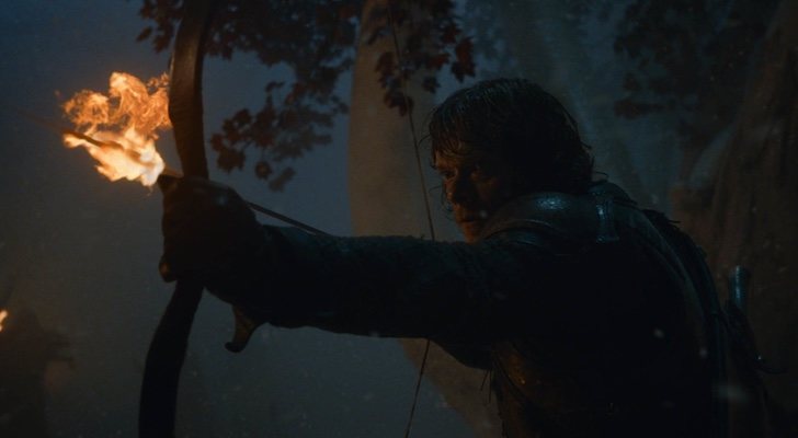 Alfie Allen como Theon Greyjoy, apenas iluminado por su flecha de fuego en "La larga noche" de 'Juego de Tronos'